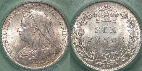 A Victoria veiled head sixpence in a Coin Grading Services slab.
