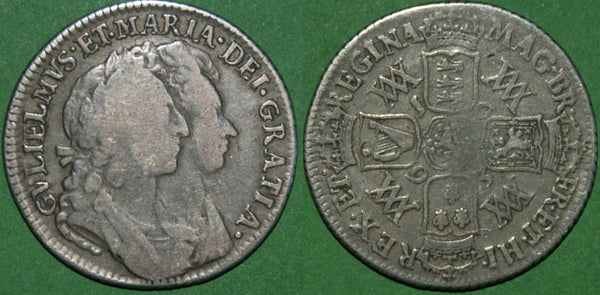 A 1693 William & Mary shilling. Toned with the portrait weak and the reverse considerably better.  The obverse is fine and the reverse nearly very fine. The price is £250.