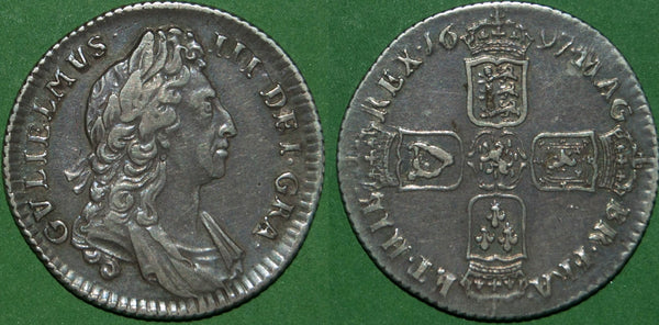 A William III 1697 first bust shilling with gunmetal toning and a thin scratch above the III. The grade is very fine or slightly better and the price is £150.