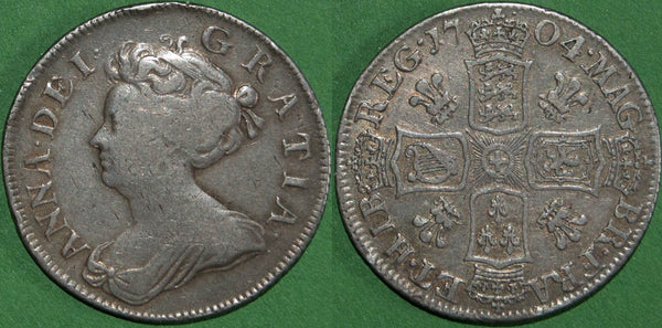 Anne 1704 pre-Union shilling with plumes in the reverse angles. There is general even wear to both sides, with the grade good fine and the reverse a bit better. The price is £250. A rare coin.
