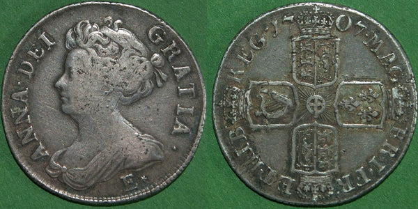 Anne 1707E* second bust shilling struck at Edinburgh from London dies with wide shields and stops after R & B (this not listed by Bull).  Toned with a couple scratches to both sides, but a decent example of this rare coin. The obverse is nearly very fine and the reverse very fine. The price is £450. 