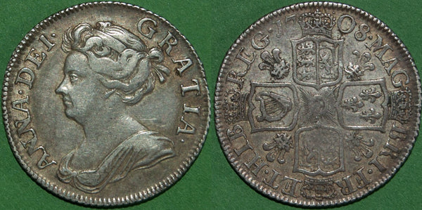 An Anne 1708 third bust shilling with plumes in the reverse angles. Toned with wear to the higher points and a rare coin. The grade is very fine and the price is £300.