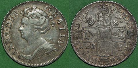 An Anne 1708 third bust shilling with plumes in the reverse angles. Toned with wear to the higher points and a rare coin. The grade is very fine and the price is £300.