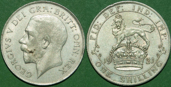 A 1921 shilling with the nose pointing to S, but weakly struck. There is minimal wear and a small rim mark by OMN. Extremely fine and the price is £50.