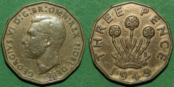 A British 1949 brass threepence showing a faulty flan with lamination errors.