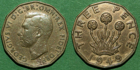 A British 1949 brass threepence showing a faulty flan with lamination errors.